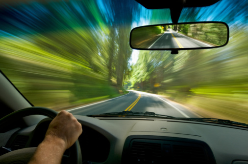 driver POV on road through forest